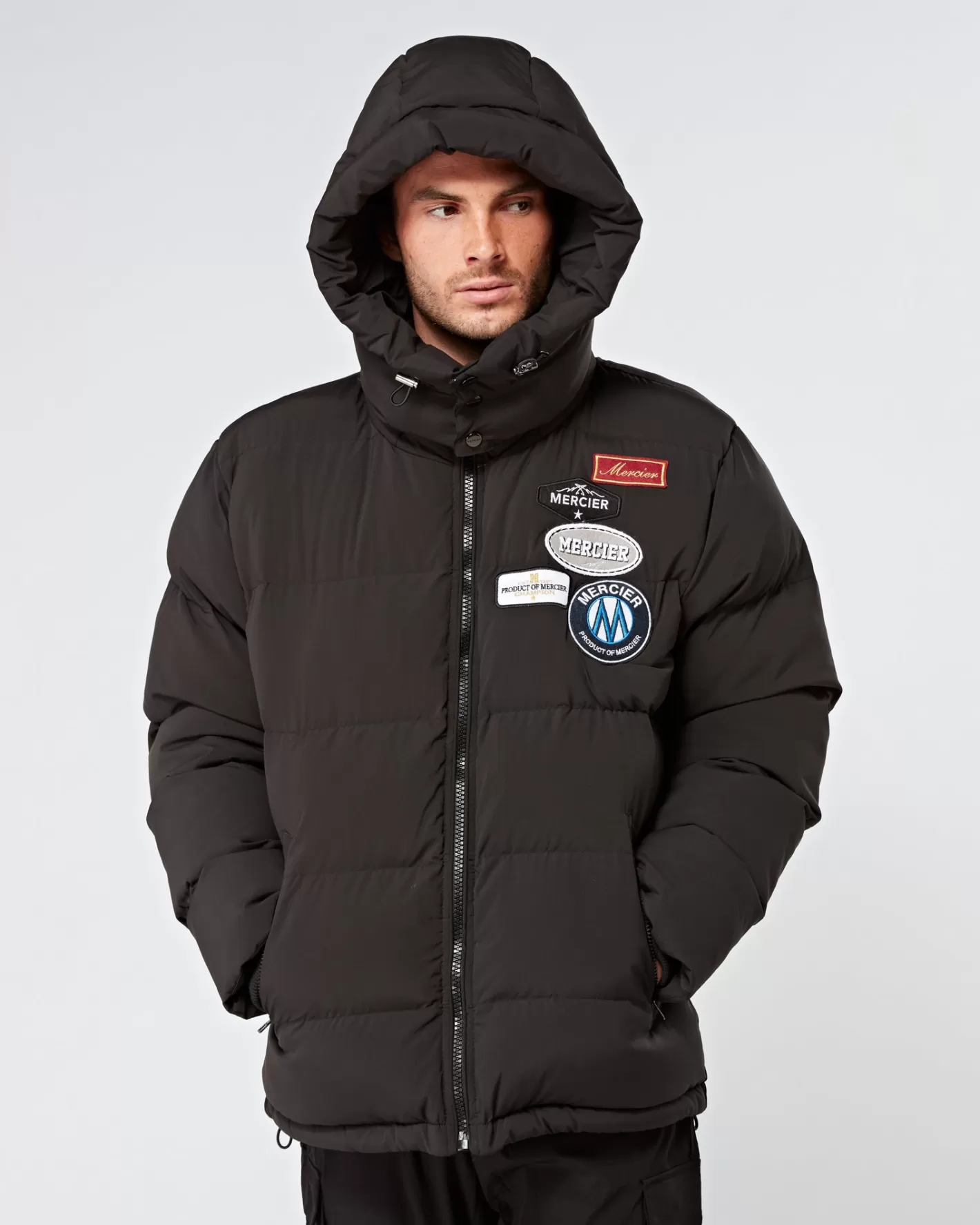 Homme Mercier Vestes<Veste matelassée noire et badge.